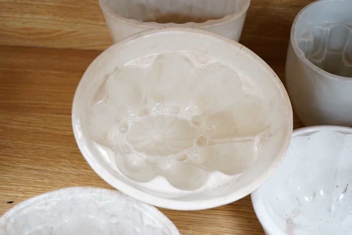A collection of fifteen mostly 20th century ceramic jelly moulds, largest 16cm high
